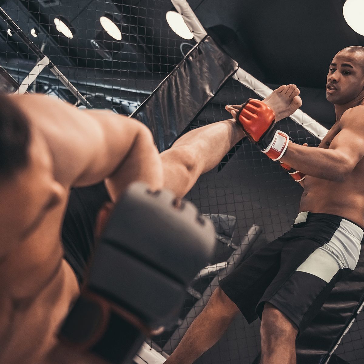 Two men in boxing gloves are fighting in a ring.