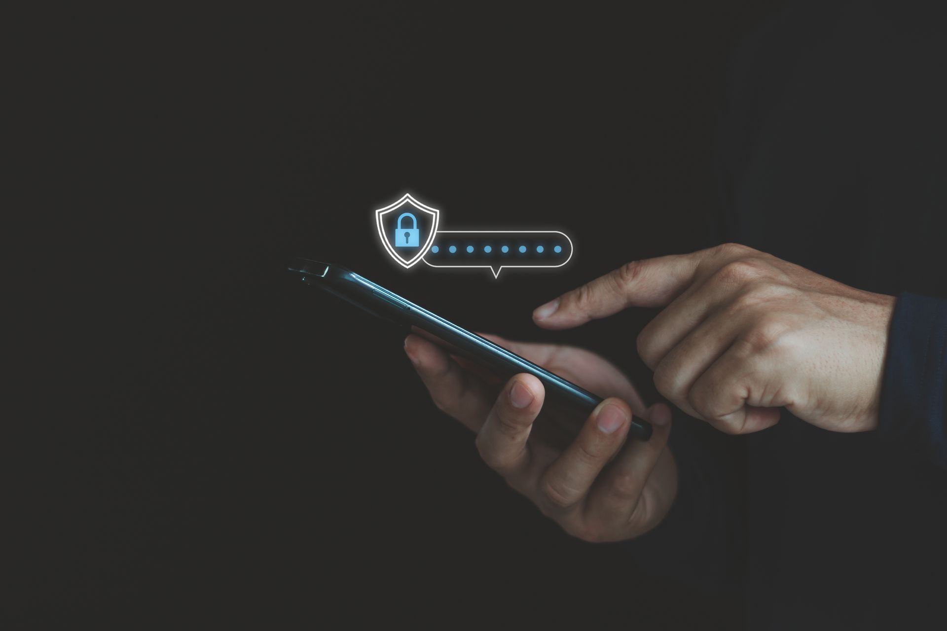 Person holding phone, finger touching a passcode entry. Shield with lock icon above. Dark background.