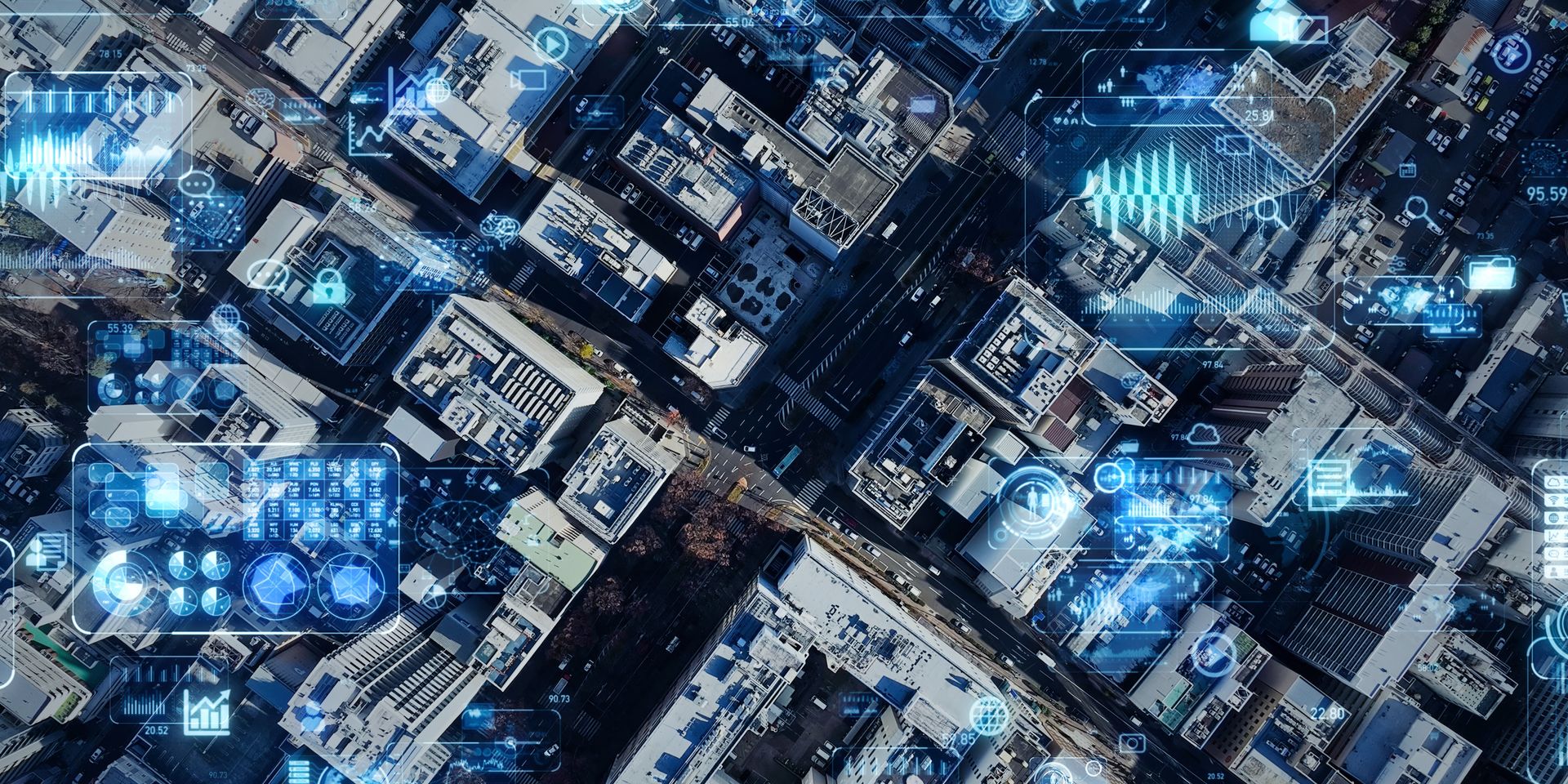 Aerial view of a city with digital overlays of data. Blue data visualization over the buildings.
