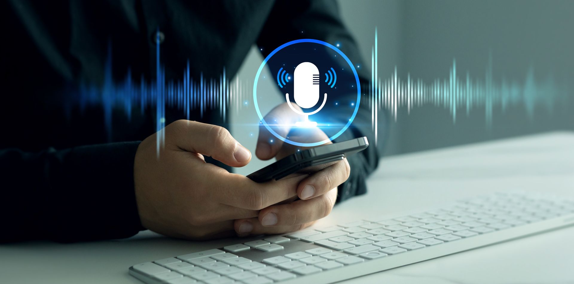 Person holding smartphone activates voice assistant, visualized with microphone icon and sound wave.