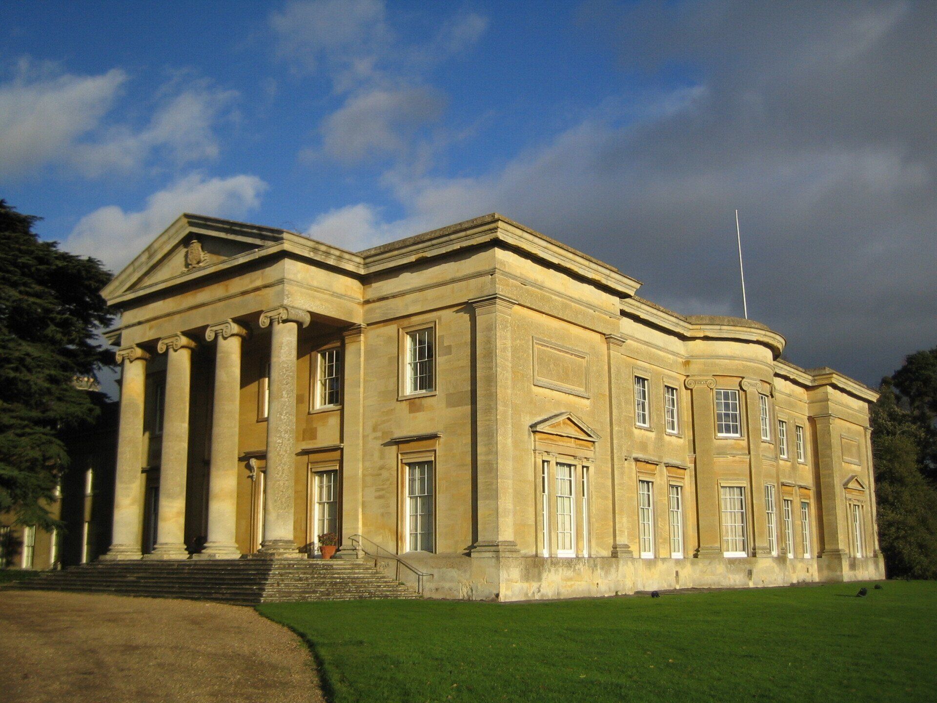 A large building with columns and a blue sky in the background