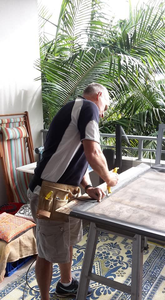 Man Repairing Fly Screen Window — North Coast Screens & Repairs in East Ballina, NSW