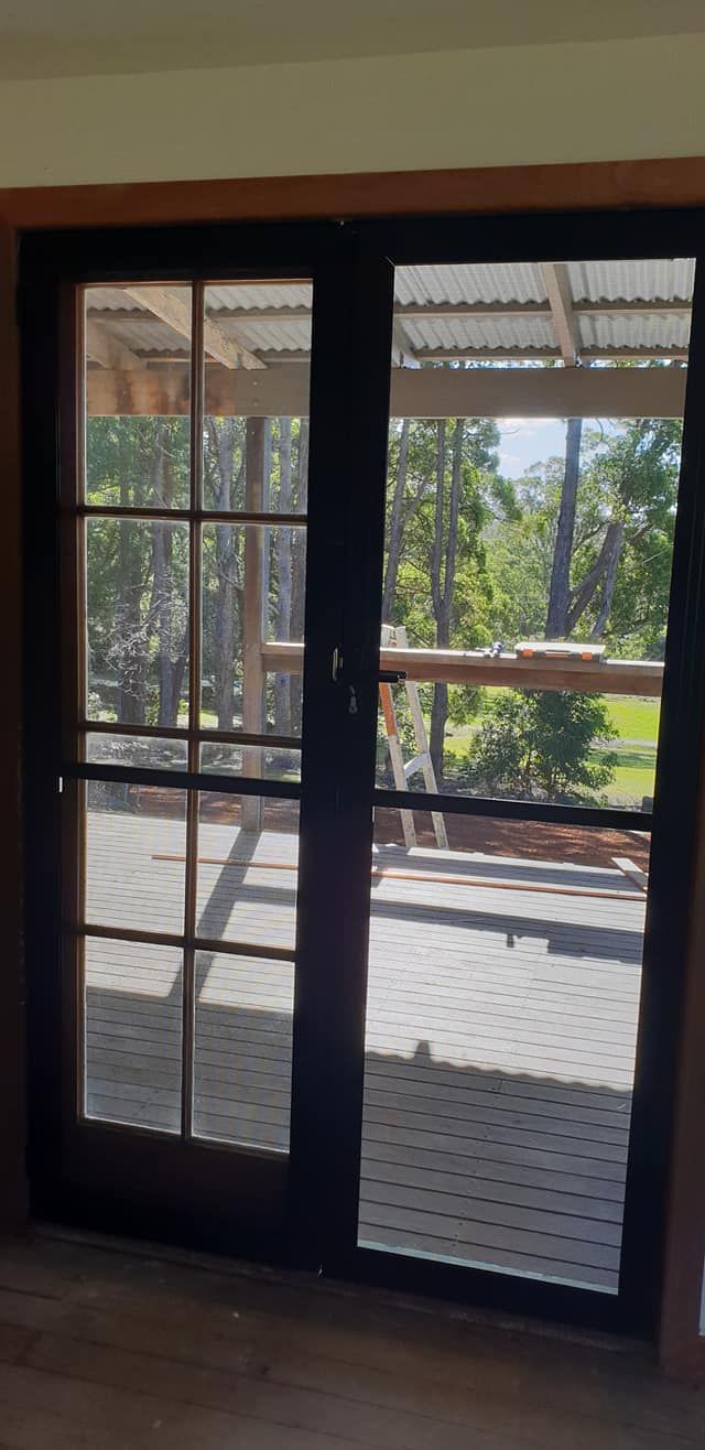 A Pair of Sliding Screen Doors Leading to a Deck — North Coast Screens & Repairs in Ballina, NSW