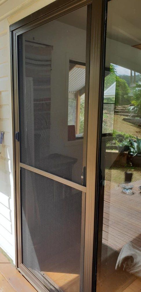 A Sliding Glass Door With a Screen on It — North Coast Screens & Repairs in East Ballina, NSW