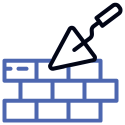 A trowel is laying on top of a brick wall.