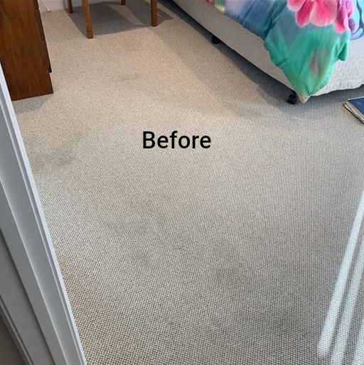 A bedroom with a bed and a rug on the floor — Dryology Carpet Cleaning in Salamander Bay, NSW
