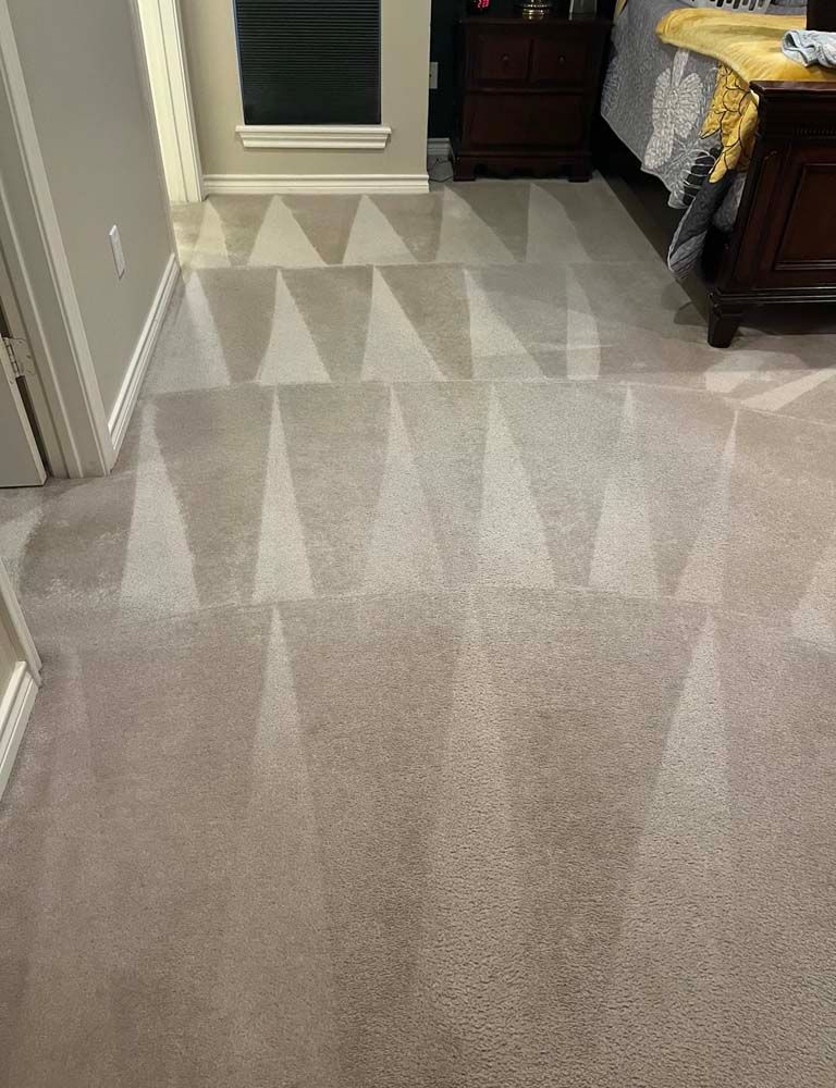 Beige carpet with geometric cleaning patterns in a bedroom.