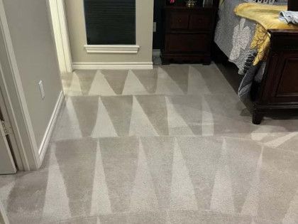 Carpeted bedroom floor with geometric cleaning patterns.