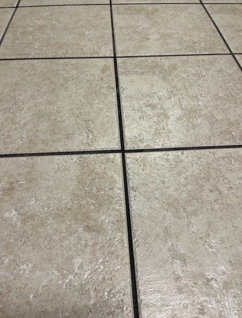 Beige tile floor with dark gray grout lines.
