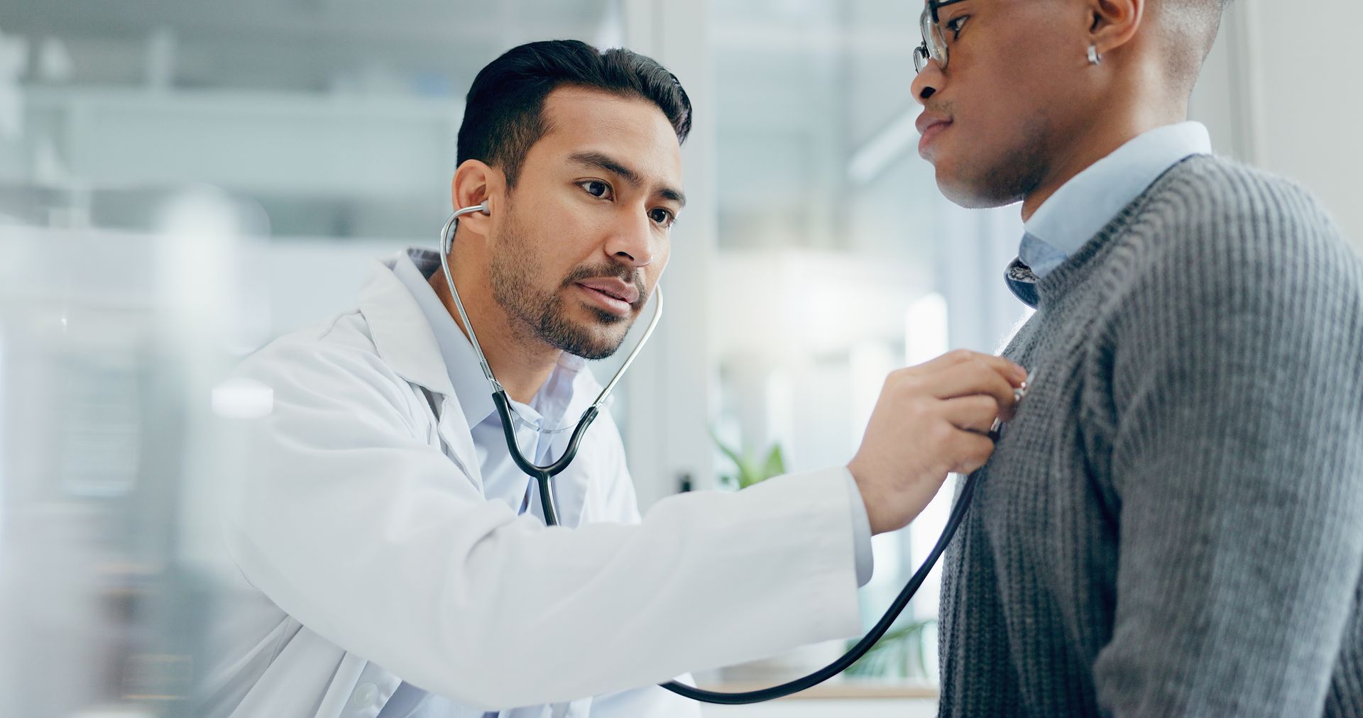 Doctor examining a patient with a stethoscope in a clinic