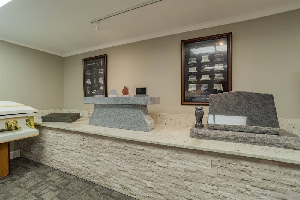 Lobby desk with stone counters, beige walls, and framed windows in a modern interior