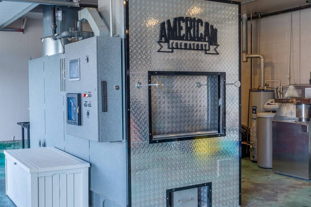 Industrial machine labeled “American Legend” in a workshop, with metal tanks and pipes nearby.