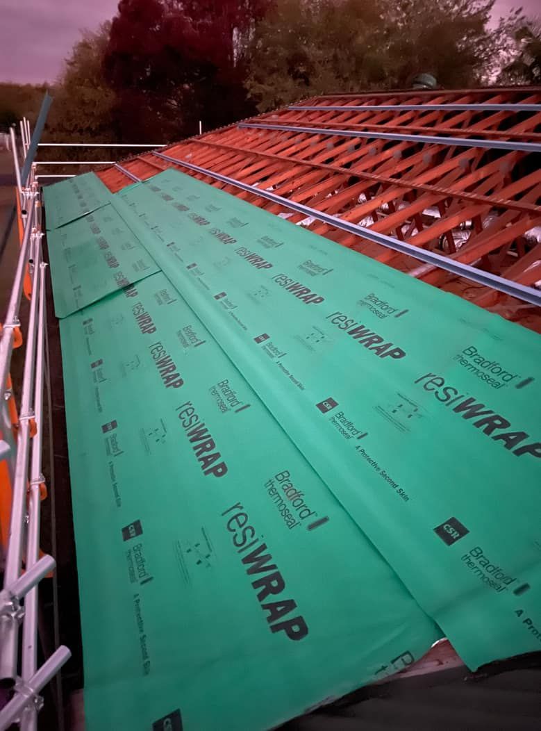 A Roof With A Lot Of Green Sheets On It — Panorama Plumbing In Dubbo, NSW
