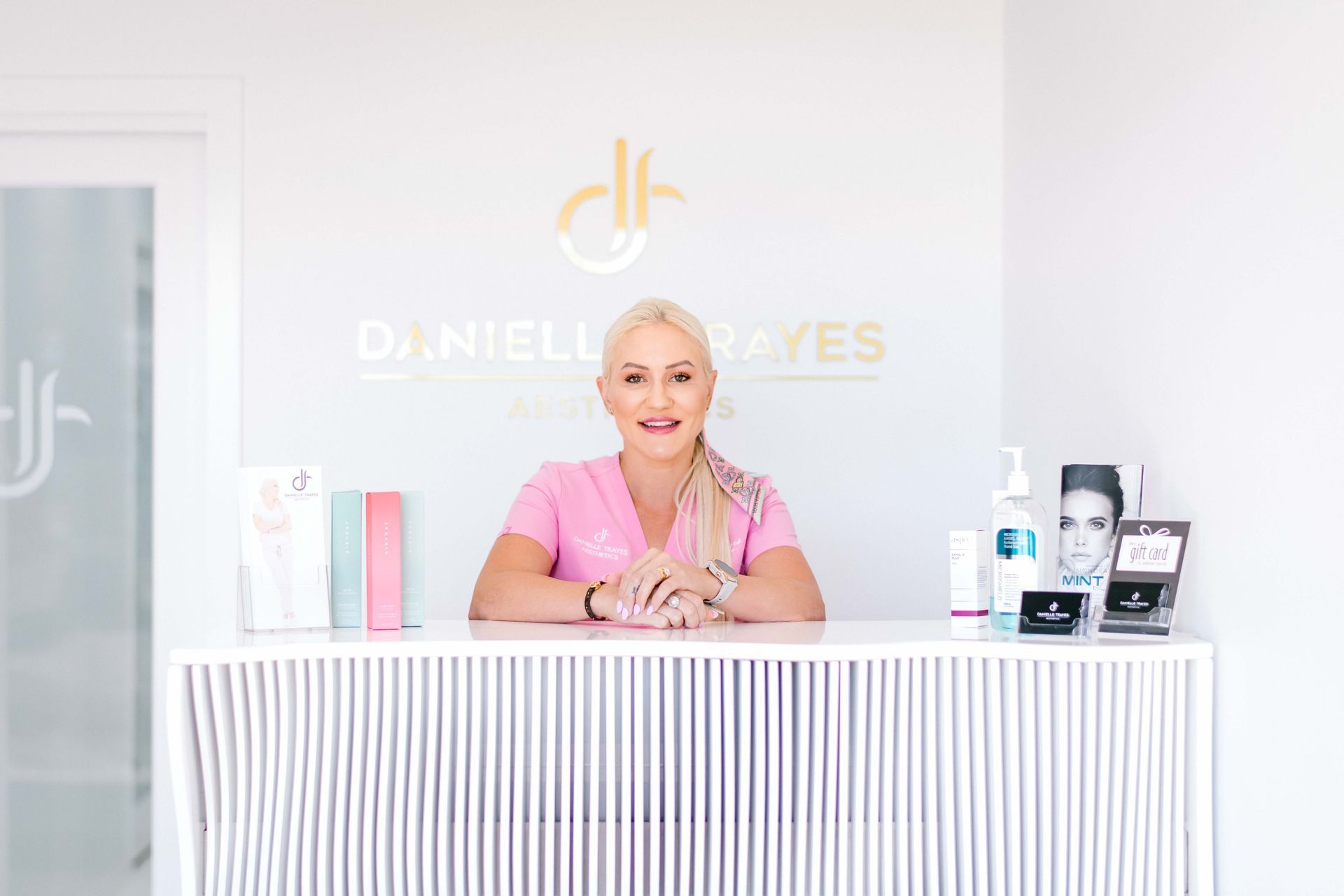 A woman is sitting at a counter in a beauty salon.