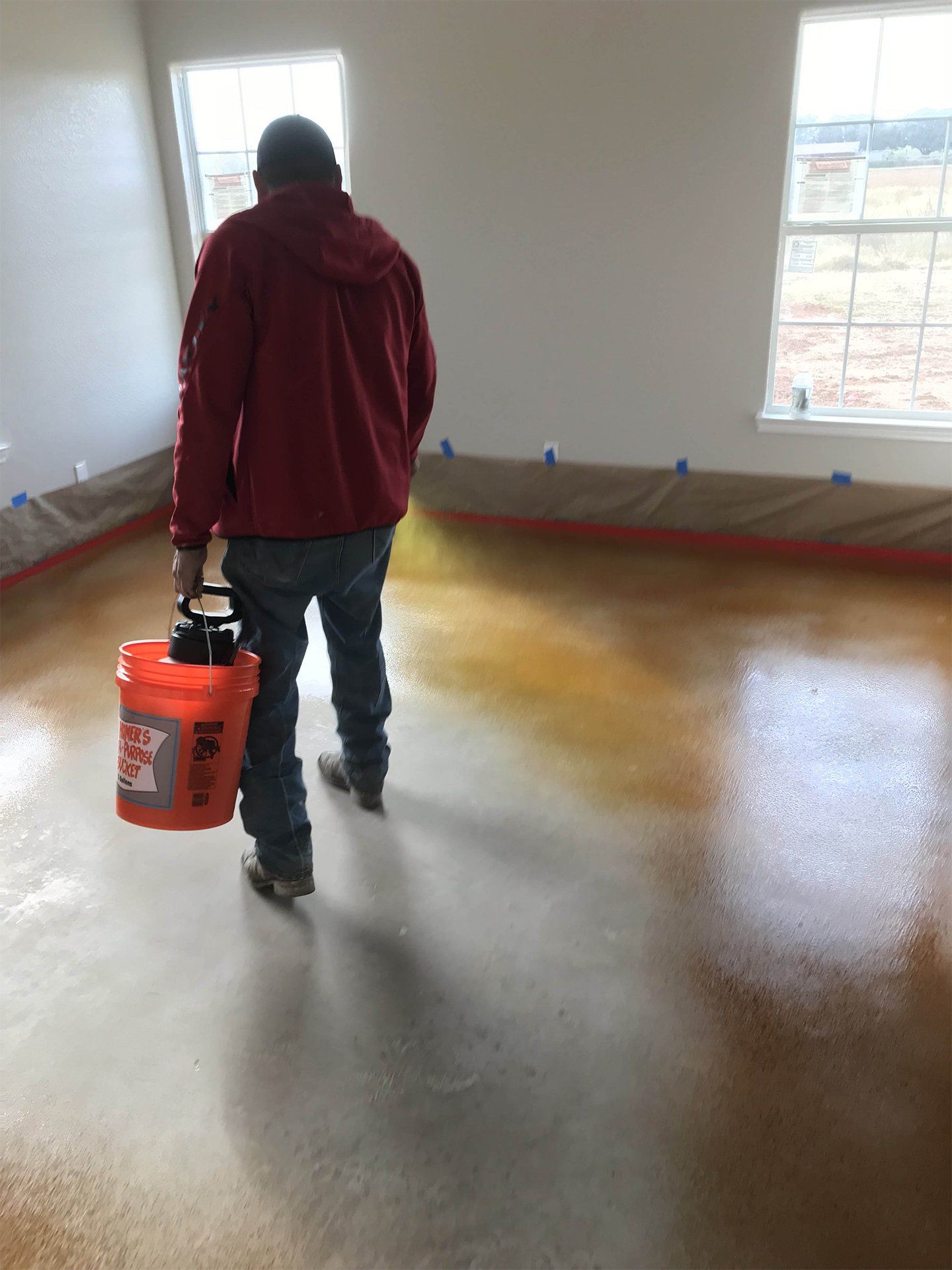 Spraying Epoxy on Concrete Floor