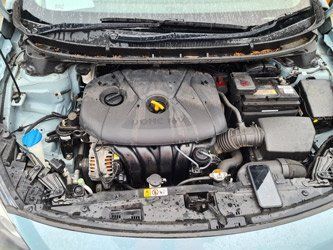 Car with the hood open showing the engine.