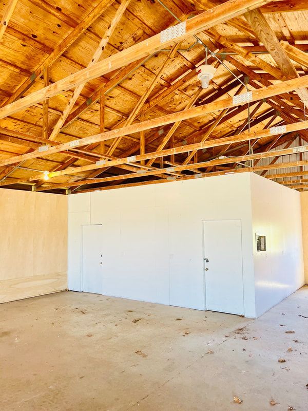 An empty room with a wooden ceiling and white walls