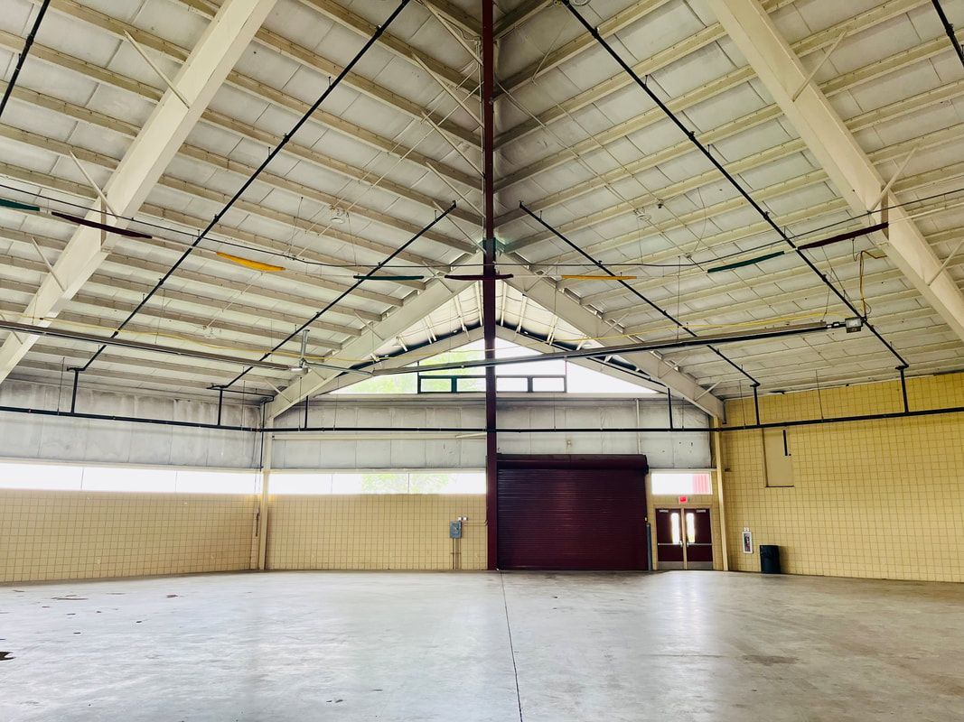 A large empty warehouse with a ceiling that is very high.