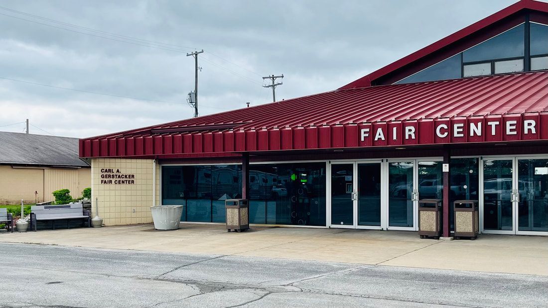 The fair center is a large building with a red roof.