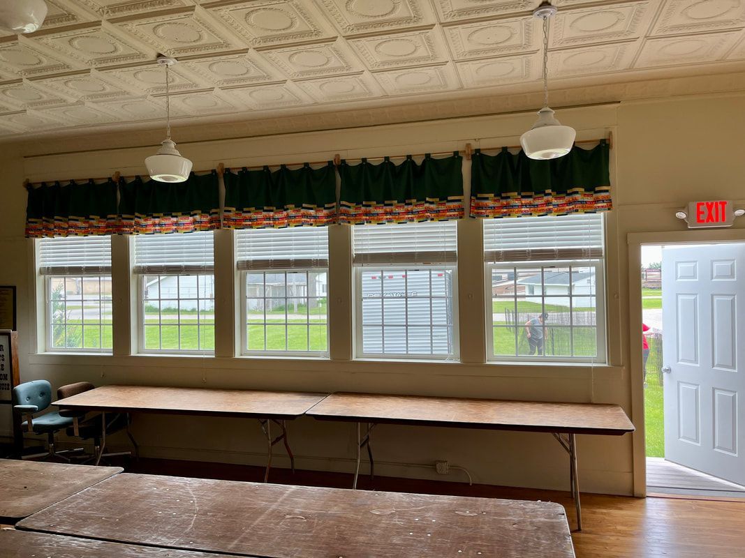 A large room with a lot of windows and tables.
