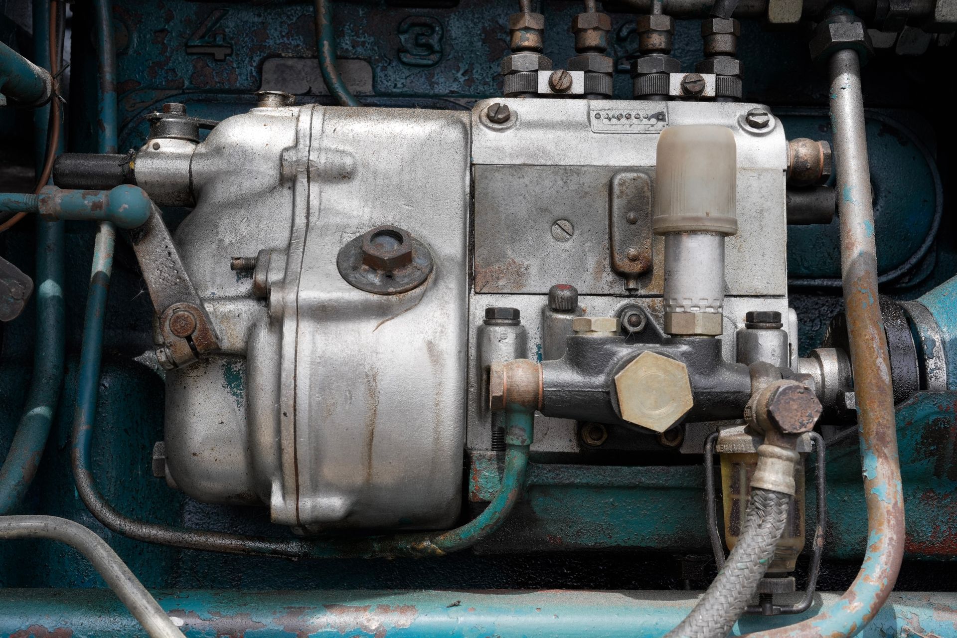 Old diesel engine fuel injection pump close up. Old diesel engine fuel injection pump close up.