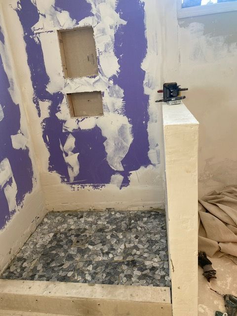 A bathroom with purple walls and a tiled floor