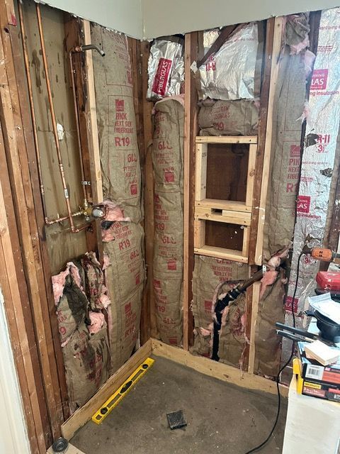 A bathroom is being remodeled with wooden walls and insulation.