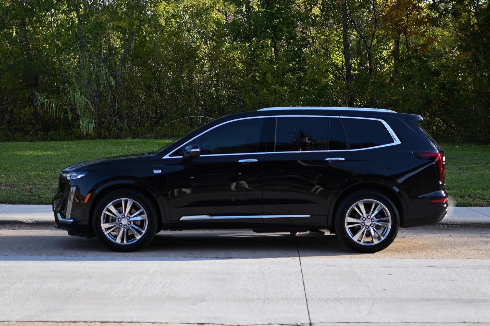 a black suv is parked on the side of the road