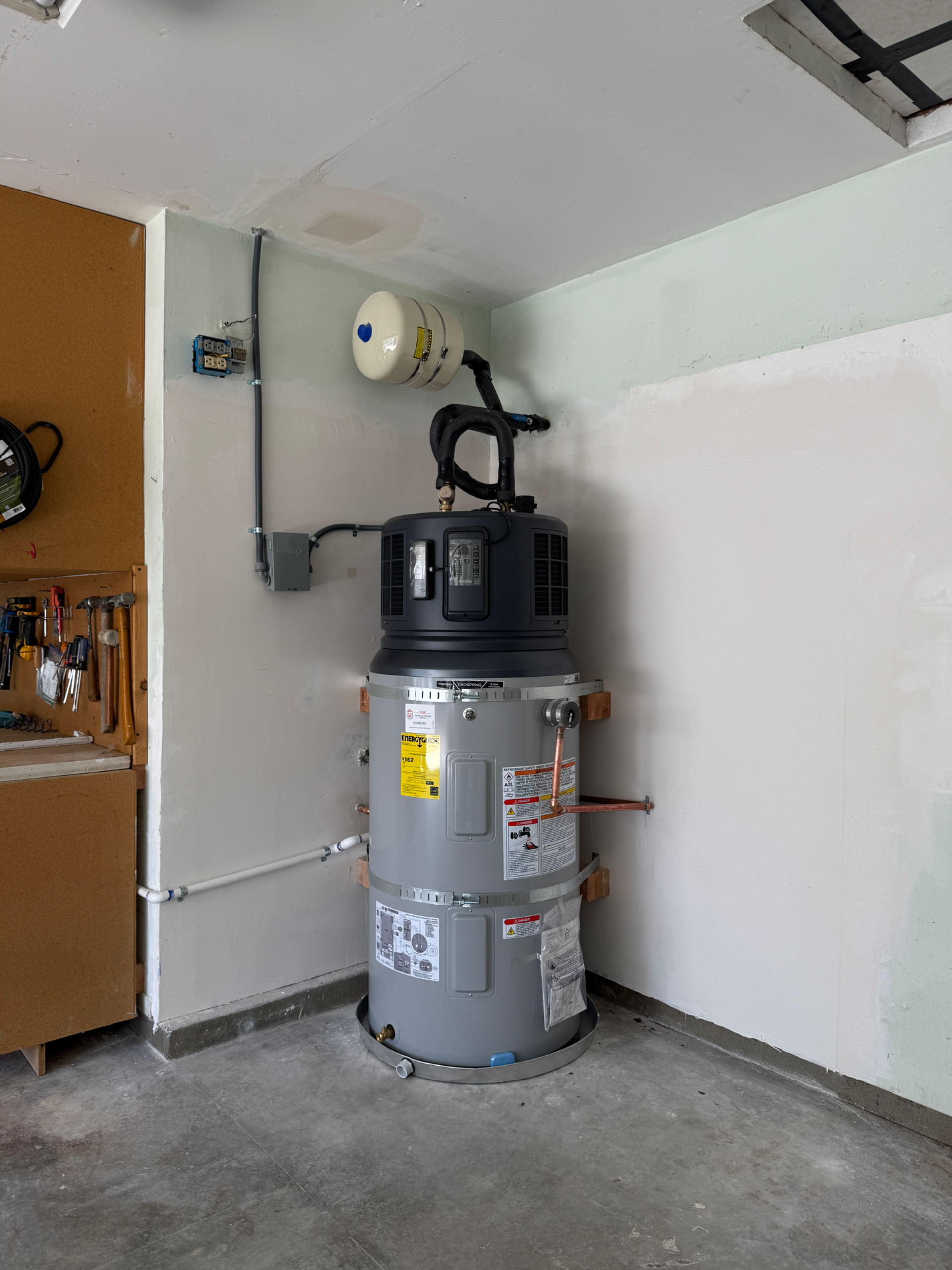 Black insulated U-shaped pipe with gauge on HVAC unit, labeled “After”