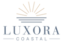 Luxora Coastal logo with gold sunburst and blue-gray text on white background