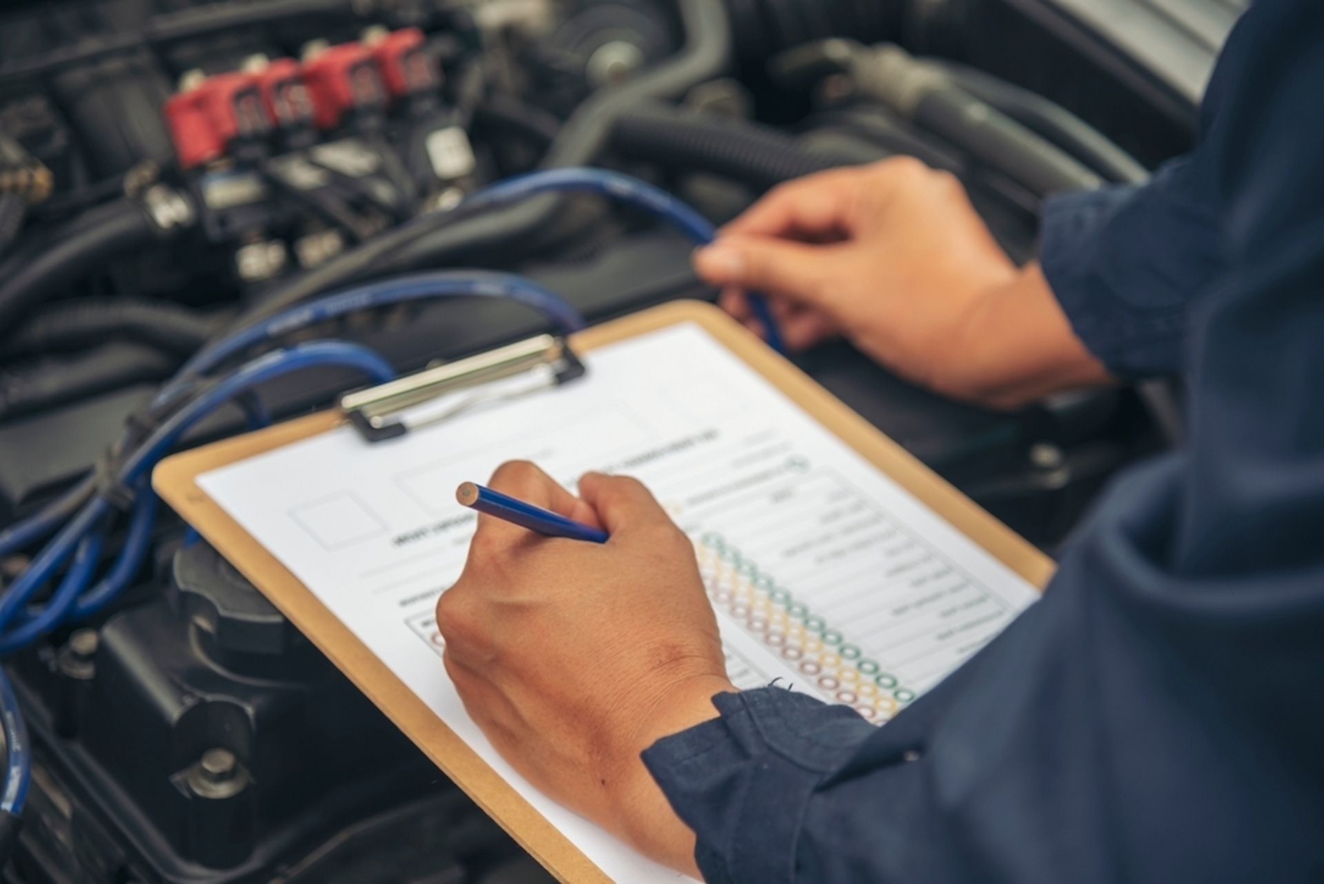 Mechanic conducting a checklist for a car service - Express Auto Repairs