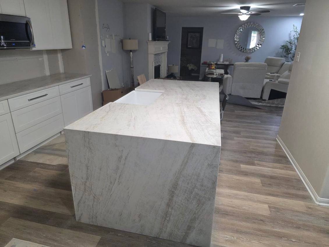 Kitchen with brown cabinets and a beige granite countertop along a wall.