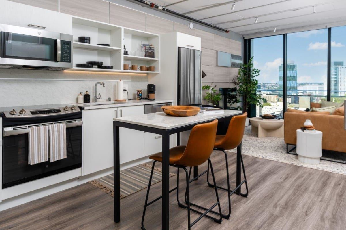 A kitchen with a table and chairs in it.
