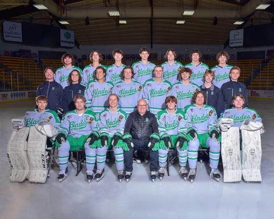 Ice hockey team posed in a rink, wearing teal jerseys with goalie gear and championship-style celebration setting