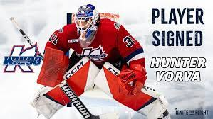 Red hockey goalie in red gear with text “Player Signed Hunter Vorva” on a Waterloo Black Hawks graphic