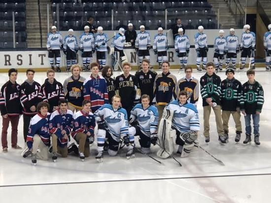 Two youth hockey teams posing on an ice rink, with one team seated and one team standing behind them.