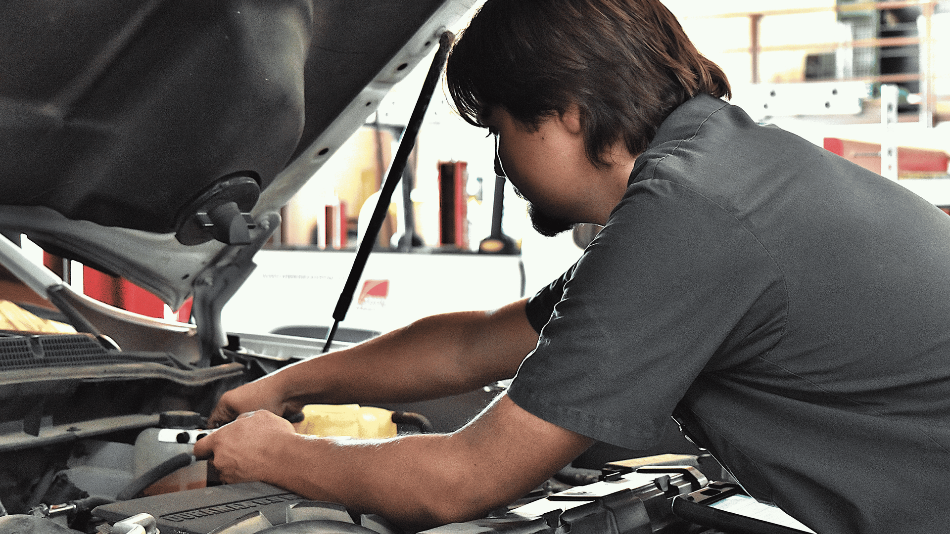 Technician performing automotive diagnostic testing to identify the cause of a vehicle problem