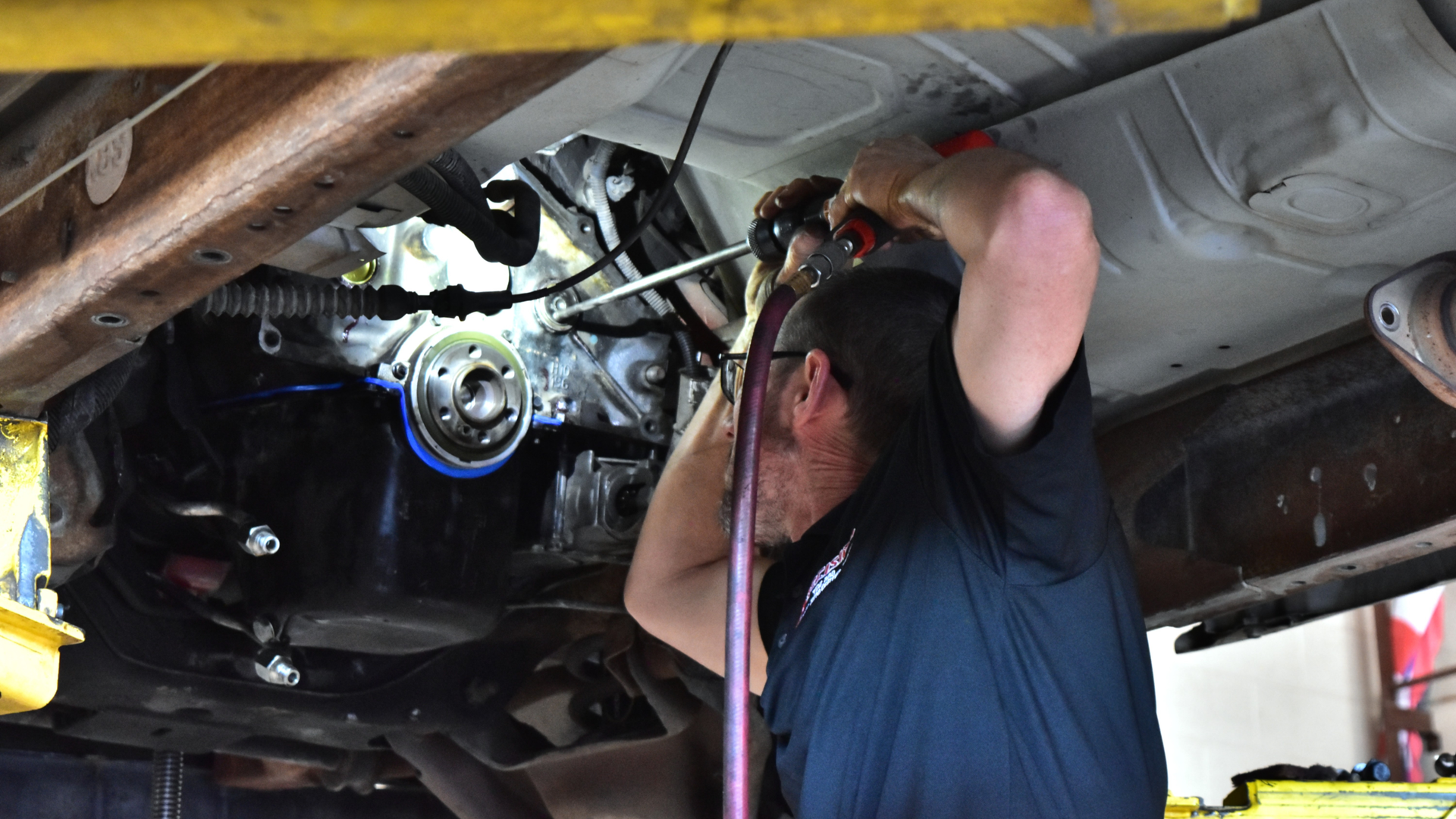 Technician  performing a freeze plug replacement during a coolant  leak repair in North Phoenix shop