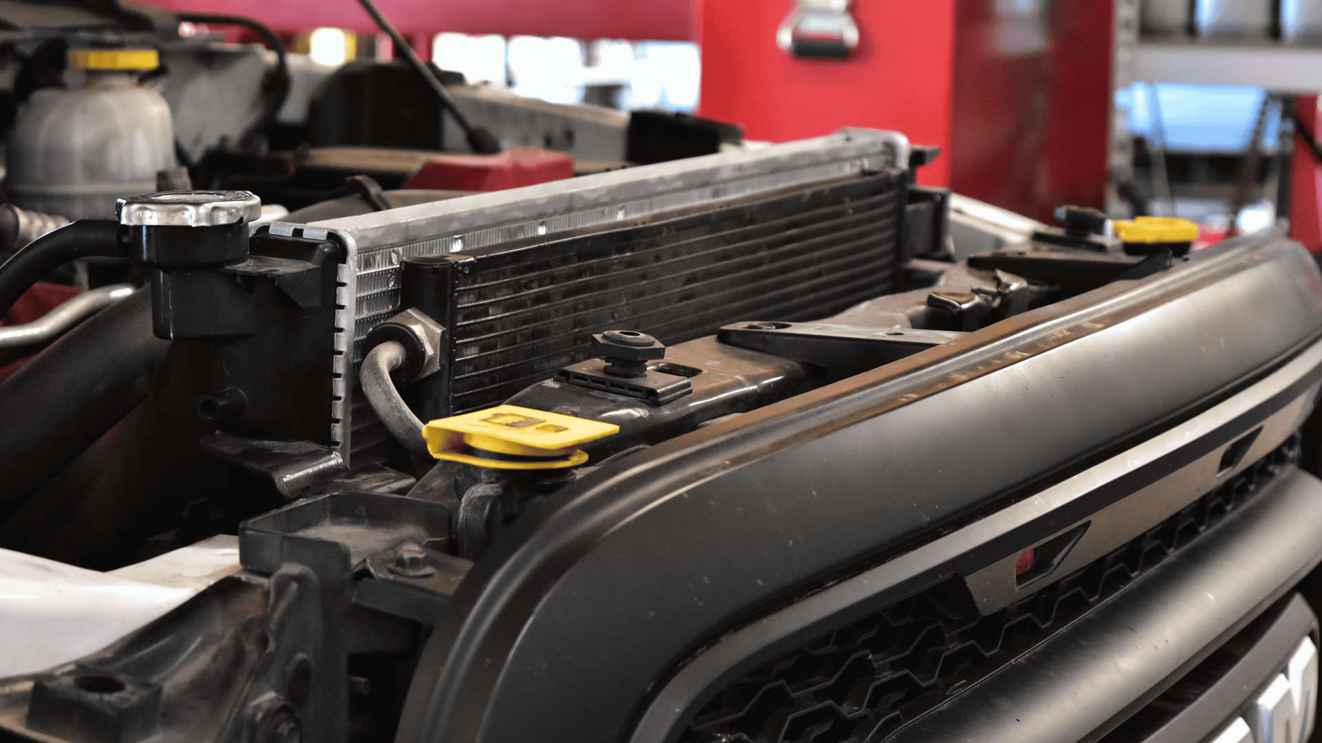 Technician-installed radiator inside a RAM truck during cooling system repair to prevent overheating
