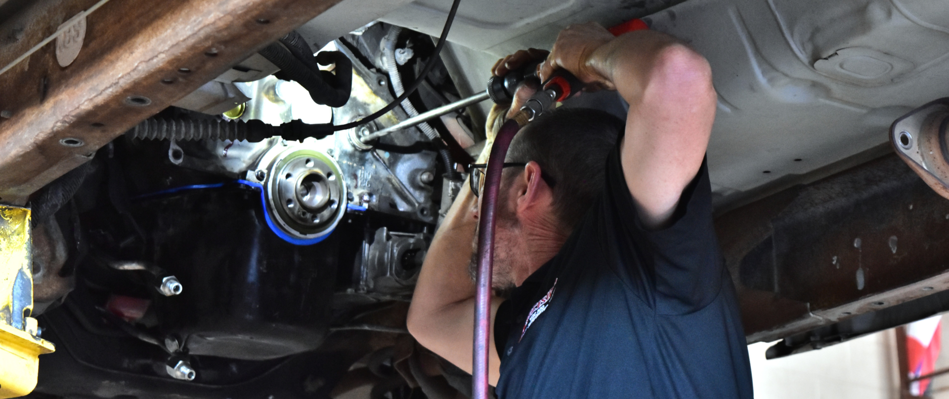 Technician performing a freeze plug replacement during a coolant leak repair in North Phoenix shop