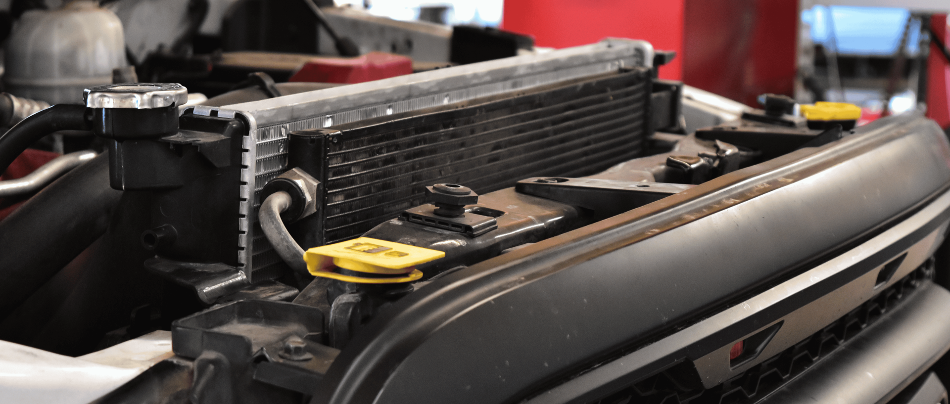 Technician-installed radiator inside a RAM truck during cooling system repair to prevent overheating