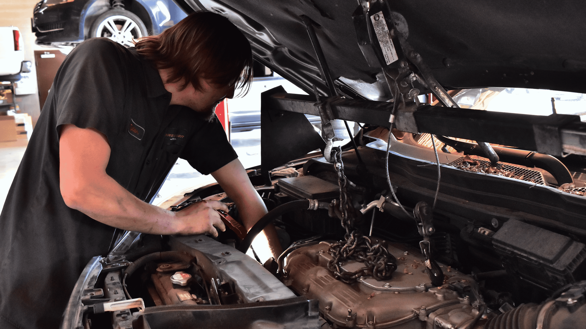 Technician performing timing belt replacement during engine service at Phoenix auto repair shop