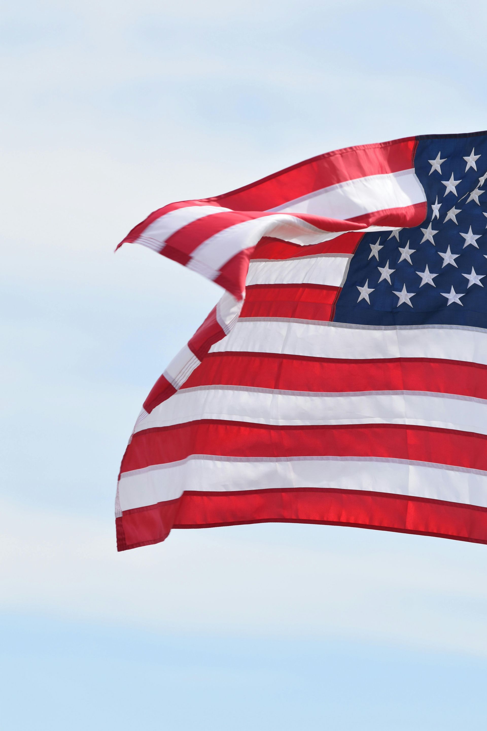 Waving U.S. flag against a blue sky