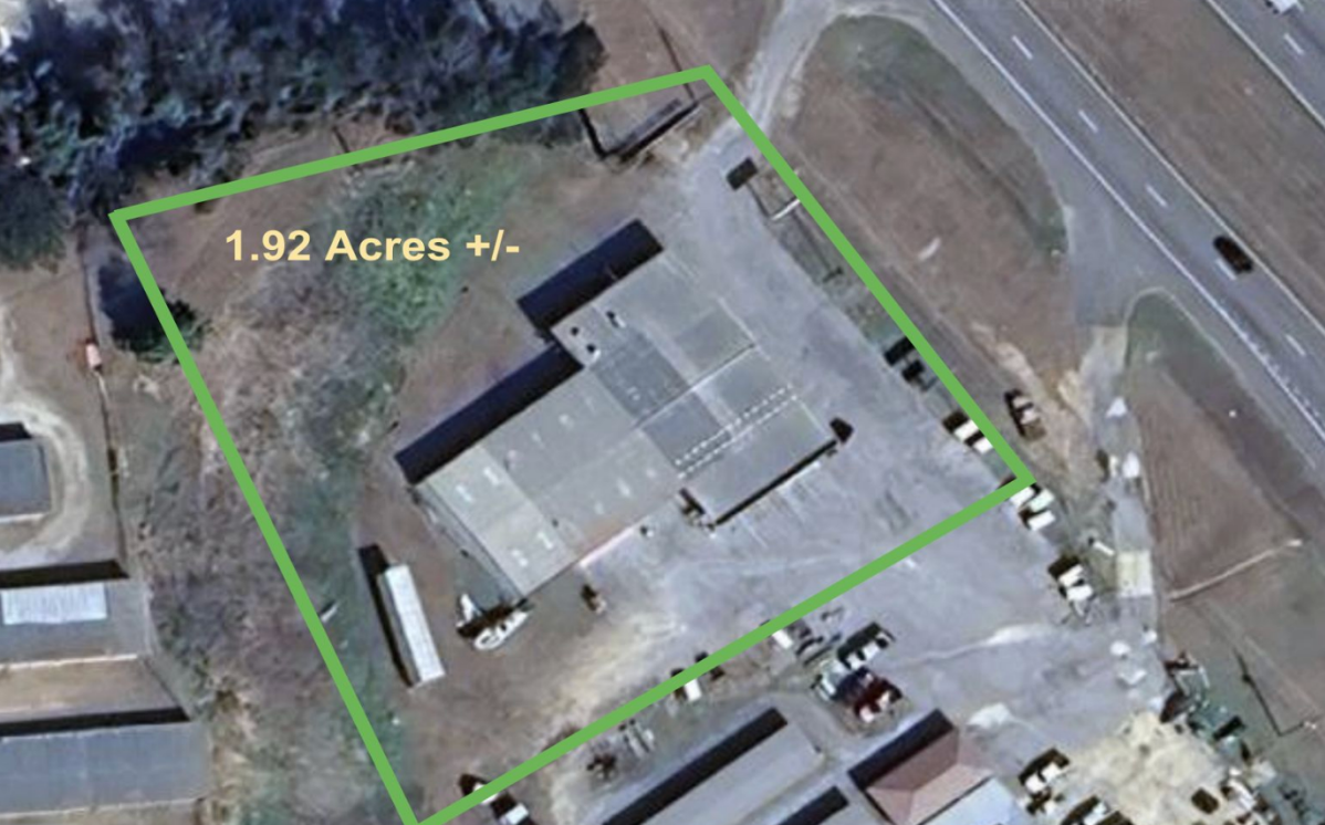 Satellite view of a rectangular property outlined in green, labeled 