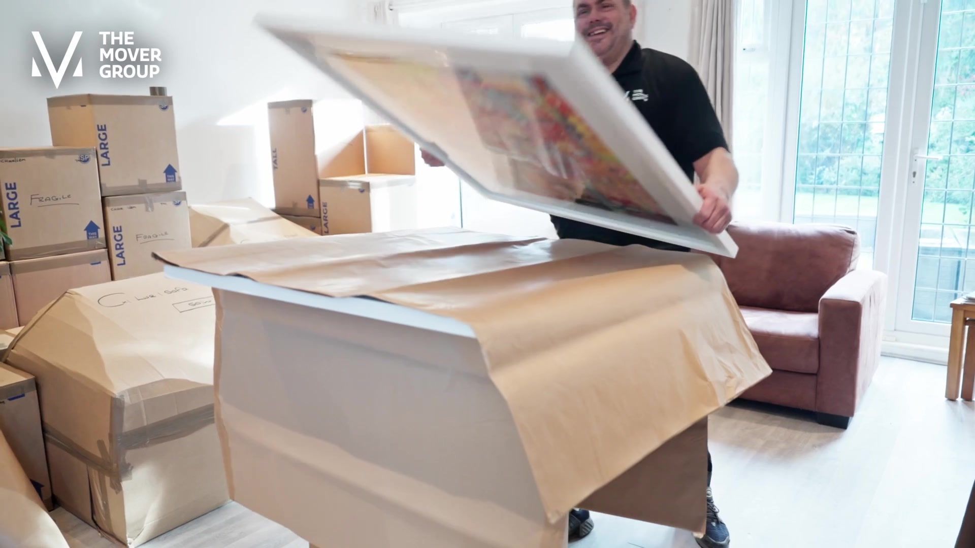 The Mover Group crew member packing a large framed artwork during day one of an international export