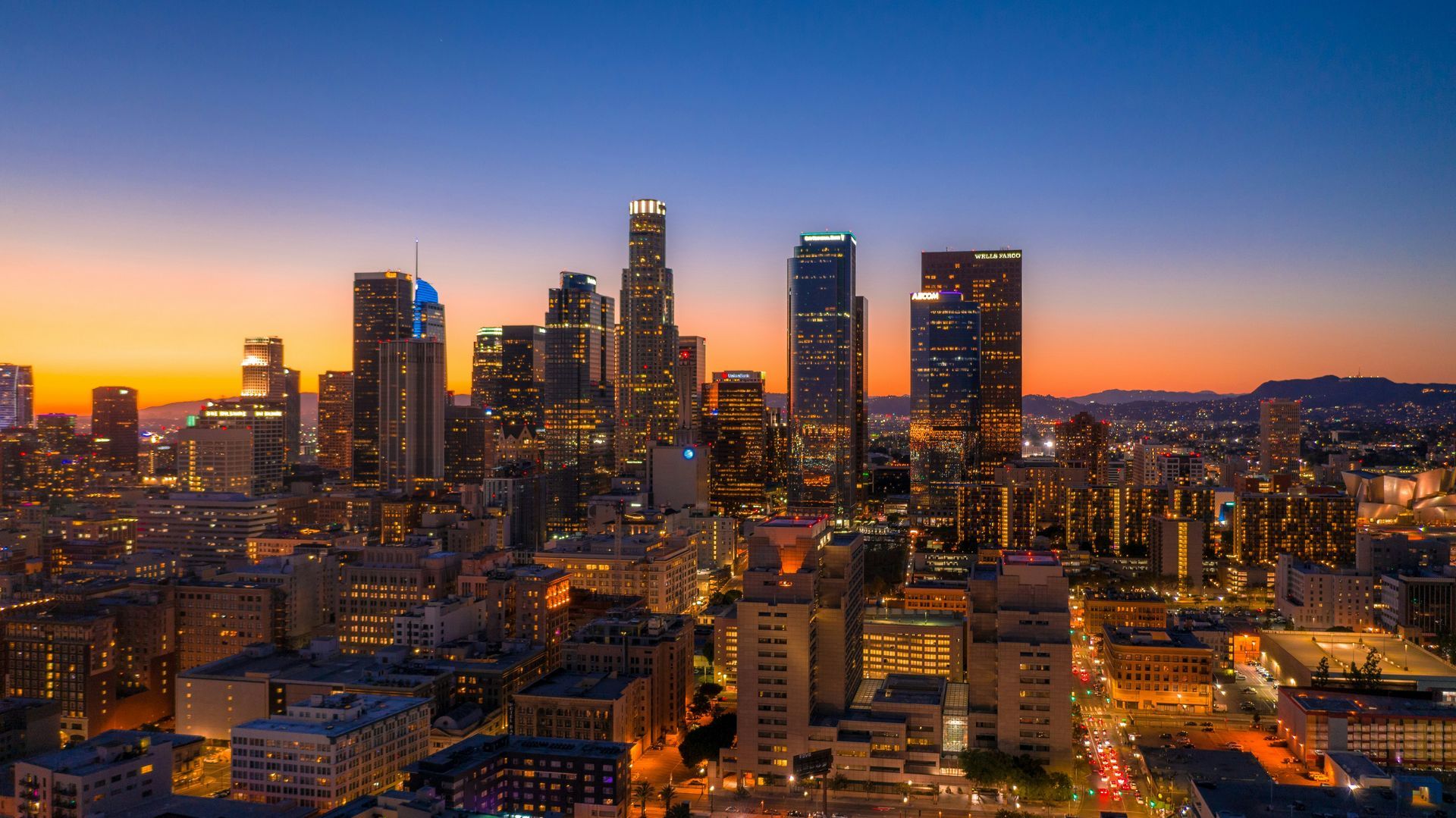 Downtown Los Angeles skyline at dusk, the view that greets households moving to Los Angeles from the UK