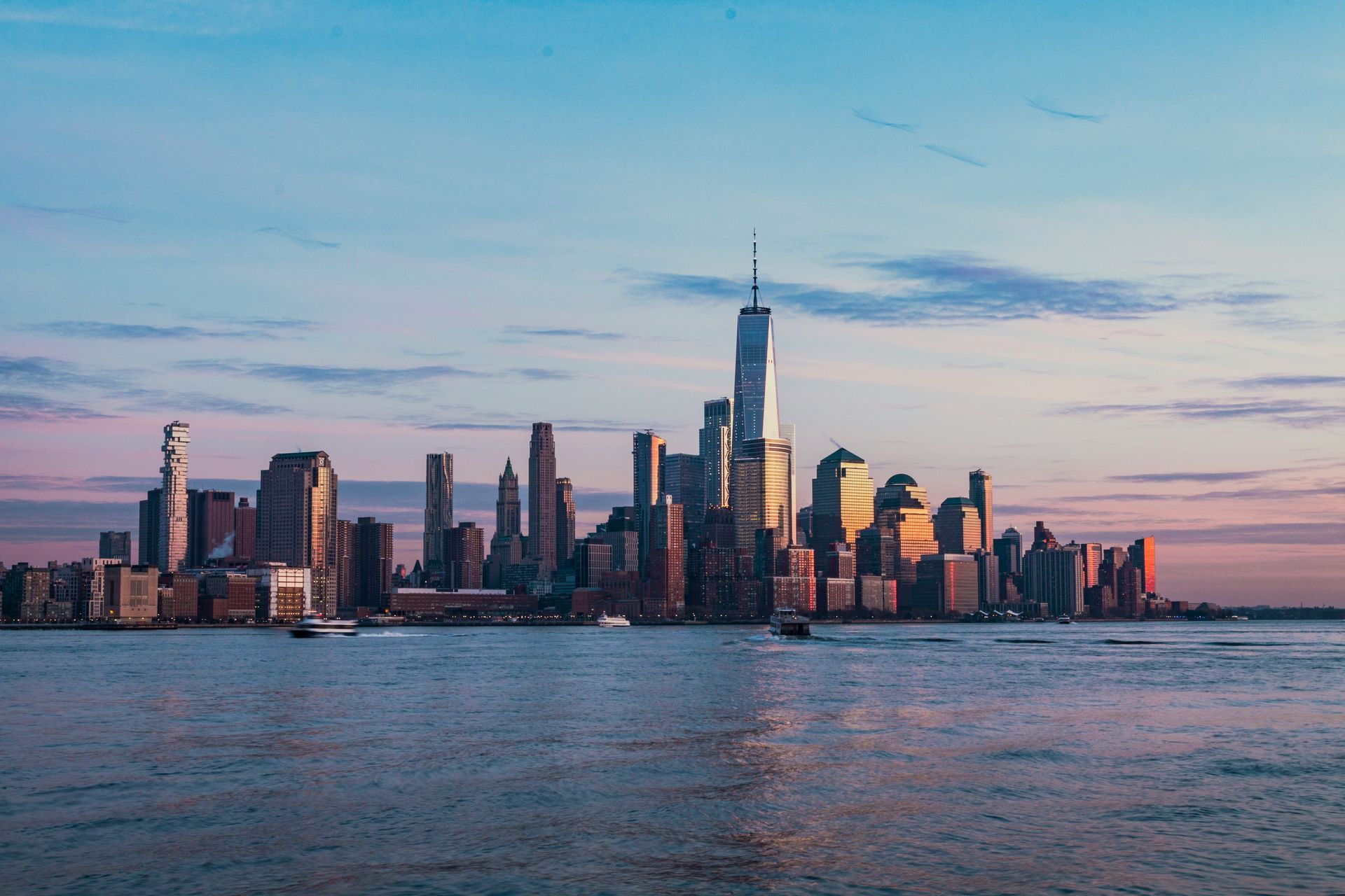 Lower Manhattan skyline at dusk seen across the Hudson River, a frequent destination when moving to