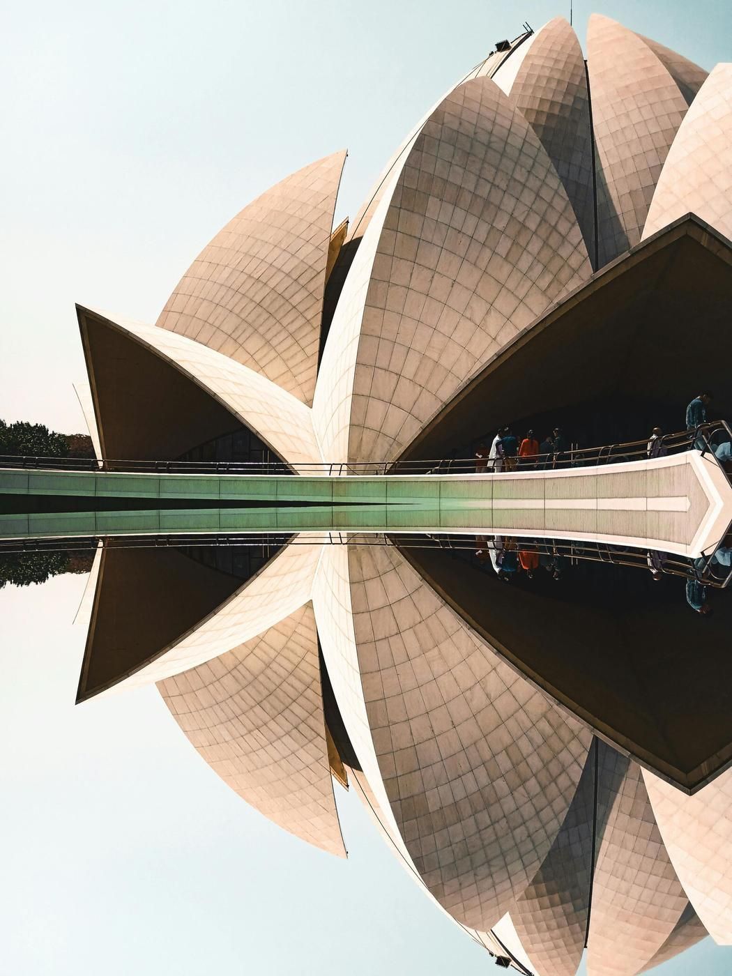 The Lotus Temple in Delhi reflected in still water, one of the cities The Indian Mover delivers to from London