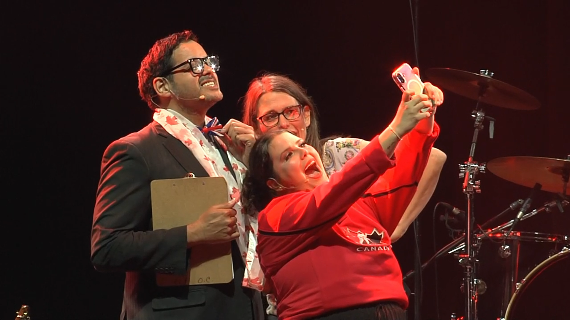 A group of people taking a selfie on a stage