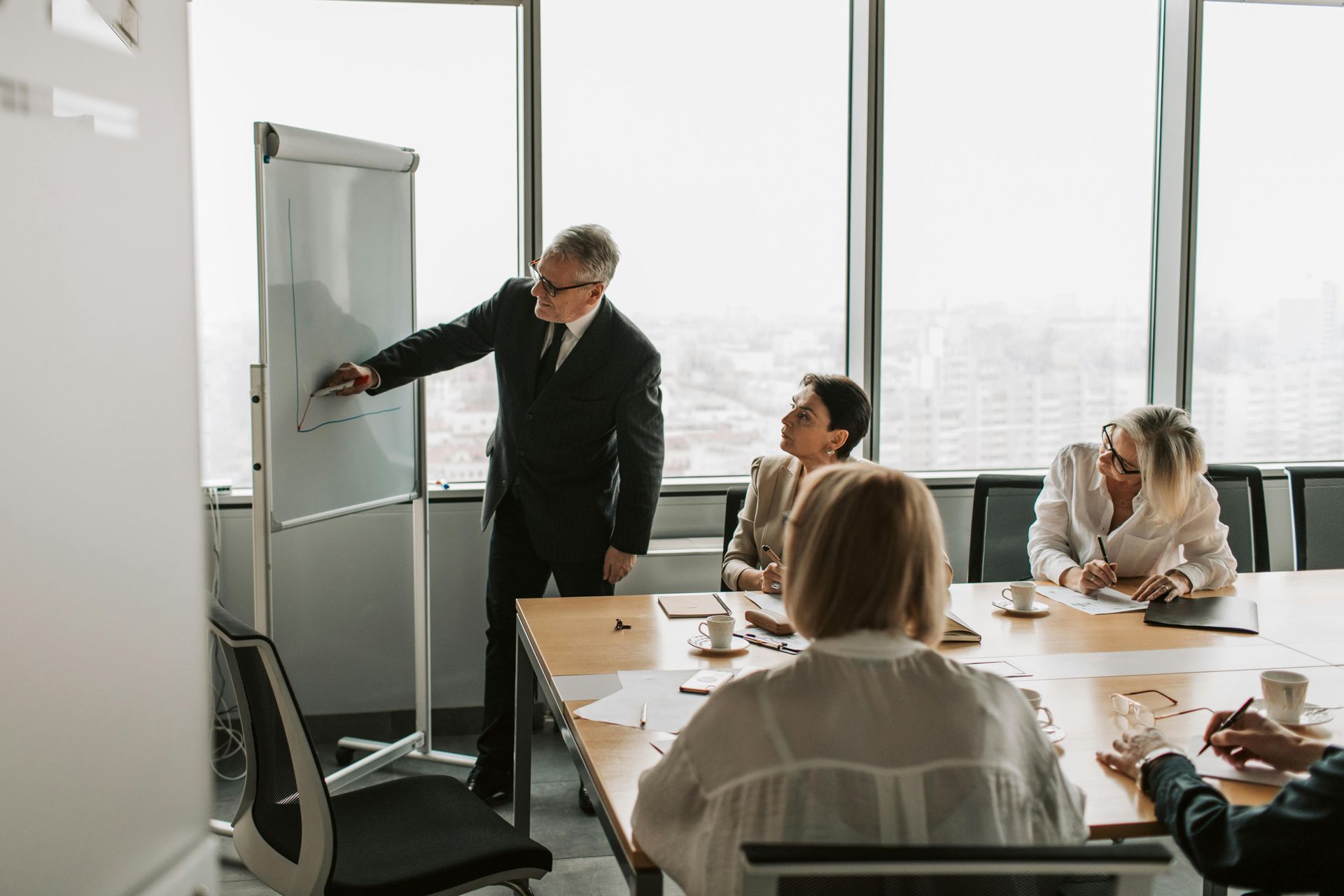 senior leader presenting talent strategy shift to team in boardroom turning talent crisis into competitive advantage